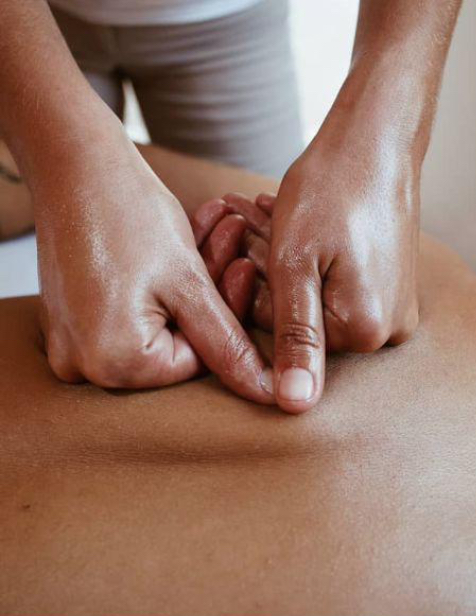 Minhas mãos trabalhando as costas de uma paciente durante a massagem